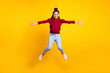 © deagreez - Full length photo of sweet cute dark skin lady wear red pullover smiling jumping high isolated yellow color background