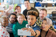 © KOTO - Team talking group selfie with smartphone in office