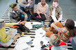 © KOTO - Team sitting on floor, discussing paperwork