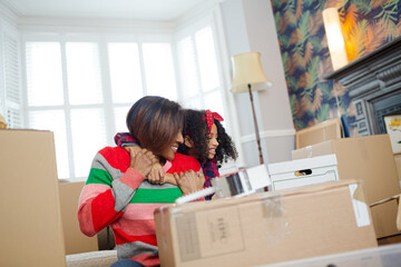 Mother and child hugging in living room