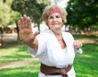 © caftor - Elderly woman in kimono is engaged in Japanese martial art in summer park