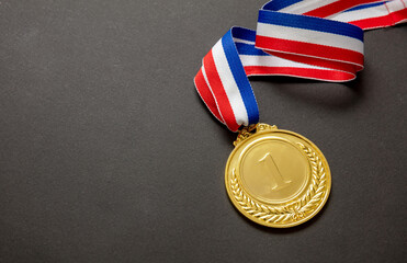 Wall Mural - Gold medal. Champion trophy award and ribbon. Prize in sport for winner isolated on black background