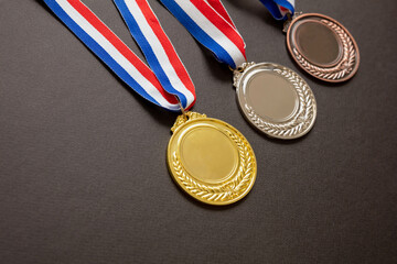 Wall Mural - Gold, silver and bronze medals set on black background. Sports athletes winners prize