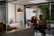 © KOTO - Couple financial planning at digital tablet in kitchen