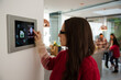 © KOTO - Woman using smart home automation system with digital tablet