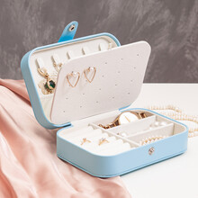 Open Blue Jewelry Box With Accessories On Gray Background. Storage System For Women's Jewelry