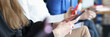 © H_Ko - Business people sitting at conference and holding documents and mobile phones in hands closeup