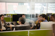 © KOTO - Businessmen talking in open plan office