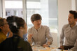 © KOTO - Business people eating sushi lunch in conference room