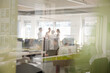 © KOTO - Business people talking in open plan office