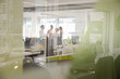 © KOTO - Business people talking in open plan office
