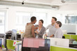 © KOTO - Business people talking in open plan office
