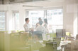 © KOTO - Business people talking in open plan office