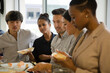 © KOTO - Happy business people enjoying sushi lunch