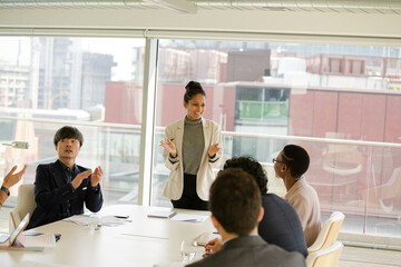 Businesswoman leading conference room meeting