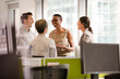 © KOTO - Business people talking in open plan office