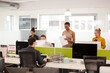 © KOTO - Business people talking in open plan office