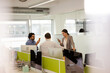 © KOTO - Business people talking in open plan office