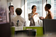 © KOTO - Business people talking in open plan office