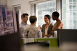 © KOTO - Business people talking in open plan office