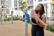 © Roman - Beautiful african american overweight young woman does fitness outdoors. Fat lady is training on sports ground for weight loss. Sport outside on warm summer day, side view, copy space. sport, workout