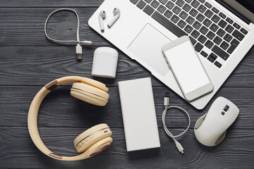 Different modern devices on dark wooden background