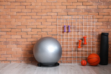 Sticker - Different sports equipment  near brick wall