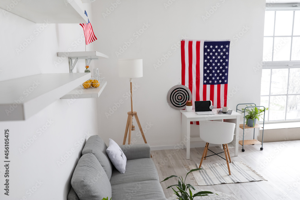 Interior of stylish room with modern workplace and USA flag