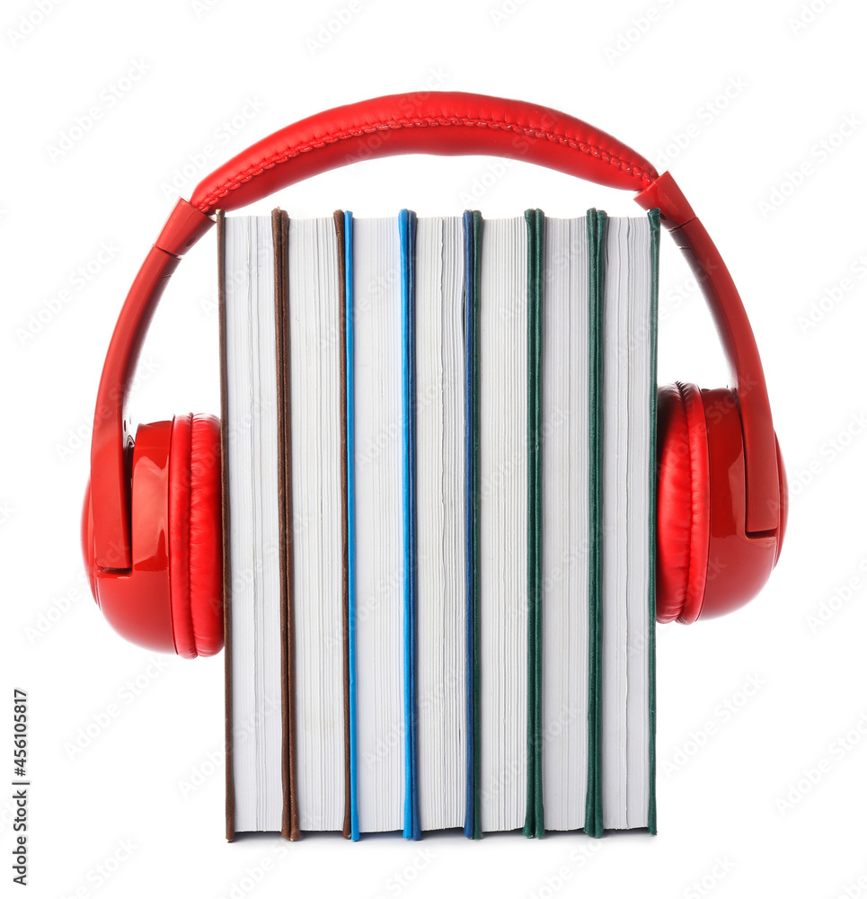 Modern headphones with books on white background