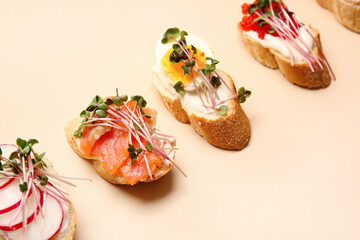 Different bruschettas with micro green on color background