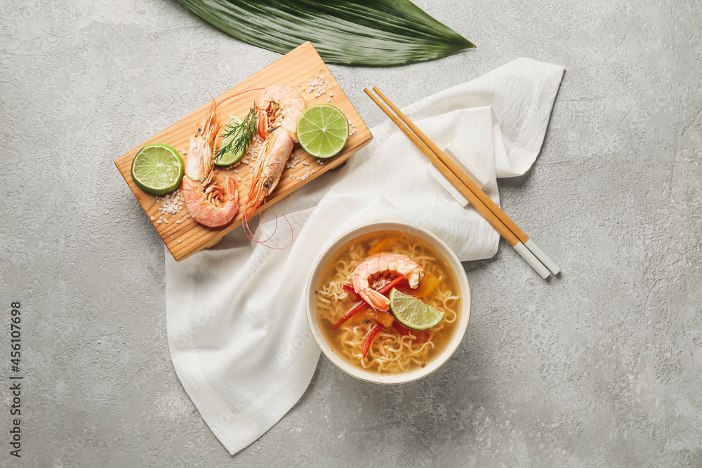 Composition with tasty Thai soup on grey background