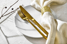 Clean Plate With Napkin And Cutlery On White Table