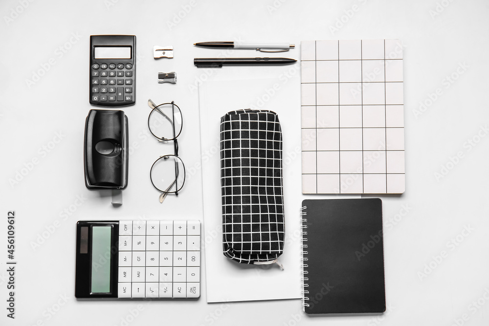 Pencil case, eyeglasses and stationery on white background