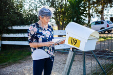 Mature Aged Woman Checking Her Mailbox For Letters