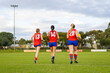 © Austockphoto - three female footballers running onto playing field