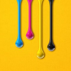 Wall Mural - cmyk ink drops on yellow paper square background