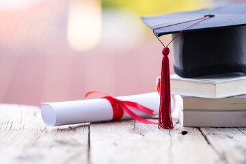 Poster - Closeup shot of a graduation cap and diploma degree certificate on a table