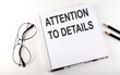© Iryna - Notepad with text ATTENTION TO DETAILS . White background. Business concept