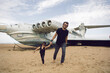 © saulich84 - family a boy and his father in rocker clothes stand at an abandoned ekranoplan plane