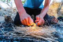 Close Up View Of A Young Male Starting A Fire With Flint And Steel Outside