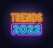 Trends 2022 neon sign on brick wall background.