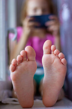 Legs Of A Girl On A Background Of A Blurred Silhouette With A Phone, Kids Games, Activities