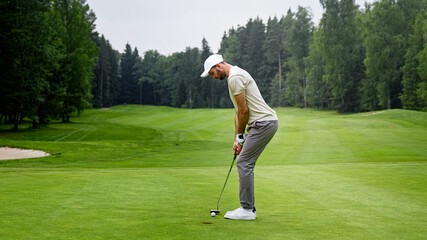 Young golfer in uniform playing golf