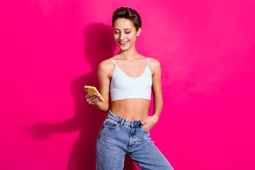 Poster - Portrait of attractive cheerful girl using device gadget chatting isolated over bright pink magenta fuchsia color background