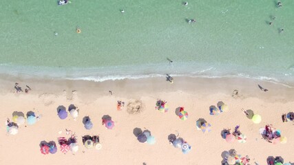 Canvas Print - people playing and relaxing in water at the beach