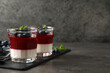 Delicious panna cotta with fruit coulis and fresh blueberries served on grey table. Space for text