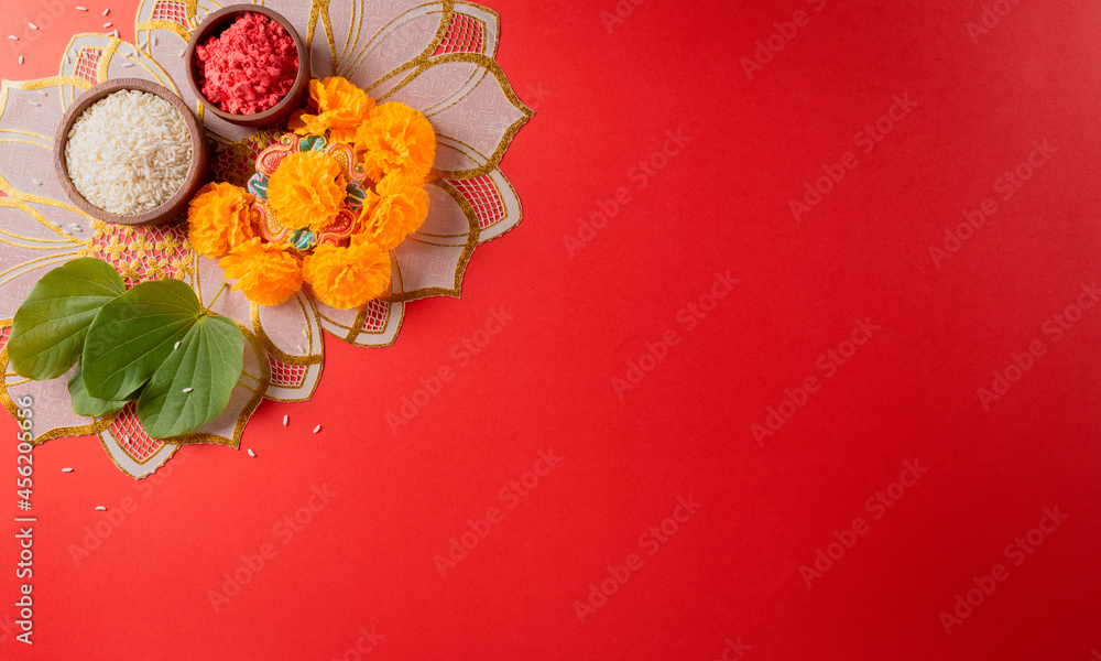 Happy Dussehra. Yellow flowers, green leaf and rice on red background ...