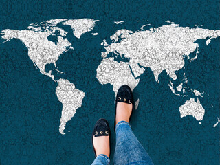 Wall Mural - World map on an asphalt road and woman in shoes
