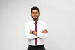 Portrait of young indian top manager in t-shirt and tie crossed arms on white isolated background