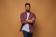 © Тарас Нагирняк - Stylish handsome indian student with crossed arms in tshirt on pastel background